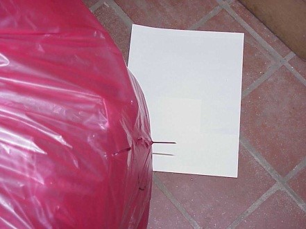 Needle breaking through a red Biohazardous Bag